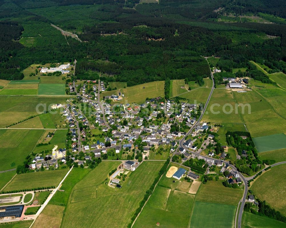 Bruchweiler from above - View of Bruchweiler in the state of Rhineland-Palatinate. The borough and municipiality is an official spa resort and located in the county district of Birkenfeld, in the Hunsrueck region. It is surrounded by agricultural land, meadows and forest. A clinic for youth and children rehab is located outside the core of the village