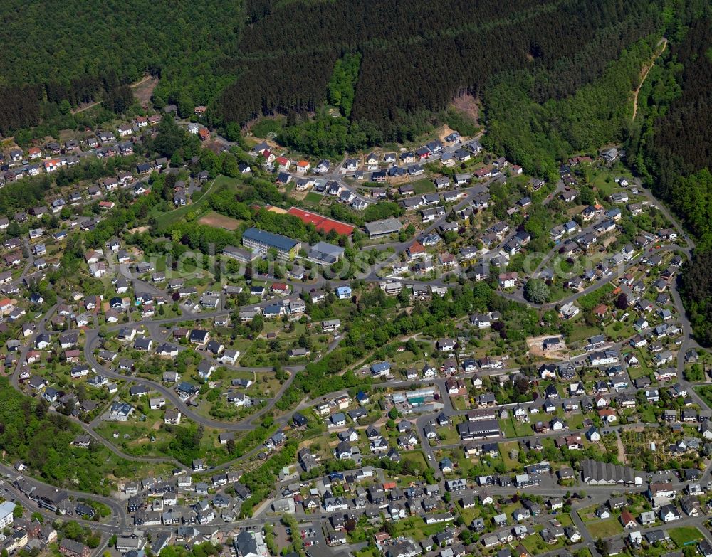 Aerial photograph Daaden - View of Daaden in the state of Rhineland-Palatinate. The borough and municipiality Daaden is located in the county district of Altenkirchen in the Westerwald forest region and surrounded by fields, meadows and forest. The official tourist resort is located right on the border to the state of North Rhine-Westphalia. The river Daade takes its course through the village