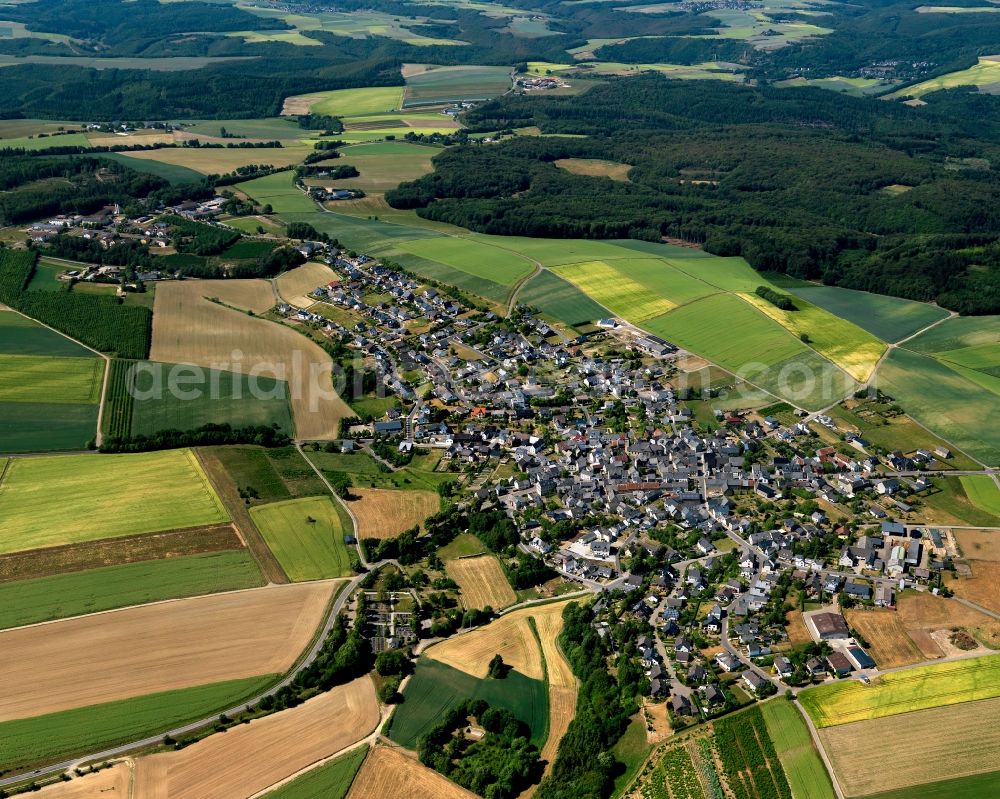 Düngenheim from above - View of Duengenheim in the state of Rhineland-Palatinate. The borough and municipiality is located in the county district of Cochem-Zell in the Eastern Eifel Region. Children's home St. Martin, Lehnholz and Weierthalerhof are hamlets of Duengenheim which is the largest municipiality in the association of municipialities of Kaiseresch. It is surrounded by agricultural land, meadows and forest