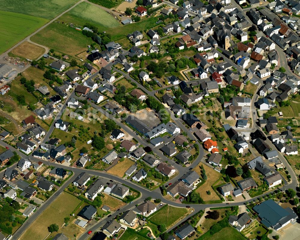 Aerial photograph Düngenheim - View of Duengenheim in the state of Rhineland-Palatinate. The borough and municipiality is located in the county district of Cochem-Zell in the Eastern Eifel Region. Children's home St. Martin, Lehnholz and Weierthalerhof are hamlets of Duengenheim which is the largest municipiality in the association of municipialities of Kaiseresch. It is surrounded by agricultural land, meadows and forest