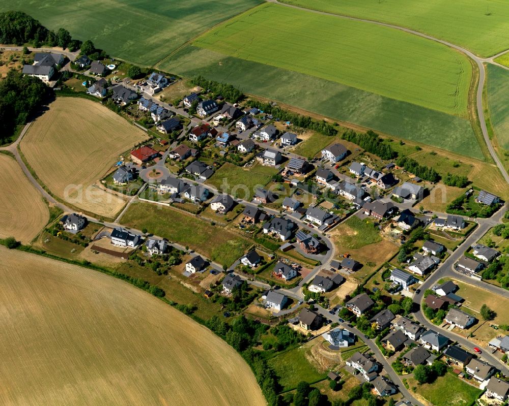 Düngenheim from above - View of Duengenheim in the state of Rhineland-Palatinate. The borough and municipiality is located in the county district of Cochem-Zell in the Eastern Eifel Region. Children's home St. Martin, Lehnholz and Weierthalerhof are hamlets of Duengenheim which is the largest municipiality in the association of municipialities of Kaiseresch. It is surrounded by agricultural land, meadows and forest