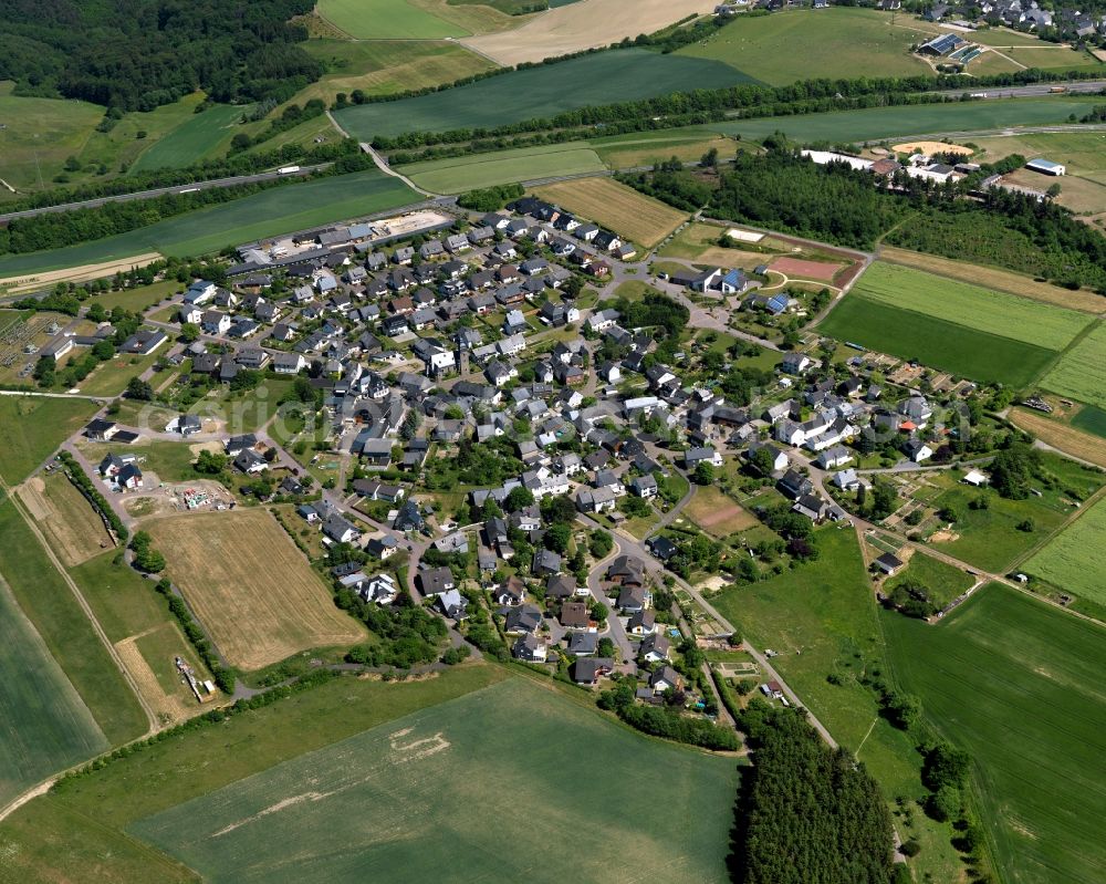 Dörth from the bird's eye view: View of the borough of Doerth in the state of Rhineland-Palatinate. The borough and municipiality is located in the county district of Rhine-Hunsrueck, in the foothills of the Hunsrueck region. The agricultural village consists of residential areas and is surrounded by fields and meadows. Doerth is located on federal motorway A61