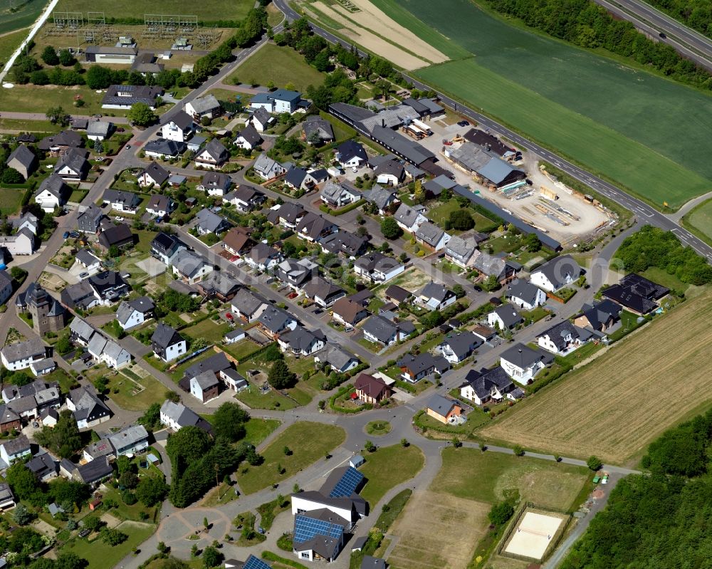 Aerial image Dörth - View of the borough of Doerth in the state of Rhineland-Palatinate. The borough and municipiality is located in the county district of Rhine-Hunsrueck, in the foothills of the Hunsrueck region. The agricultural village consists of residential areas and is surrounded by fields and meadows. Doerth is located on federal motorway A61