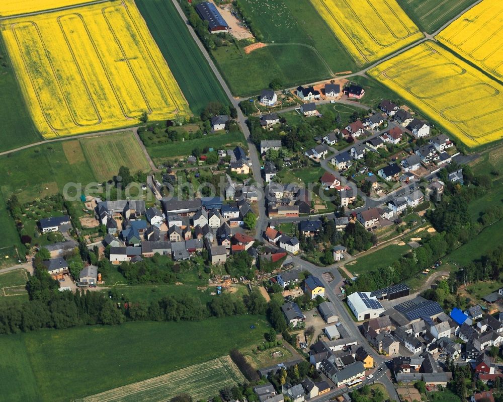 Eisighofen from above - View of the borough of Eisighofen in the state of Rhineland-Palatinate. The borough and municipiality is located in the county district of Rhine-Lahn, in the Hintertaunus mountain region. The agricultural village consists of residential areas and is surrounded by rapeseed fields and meadows