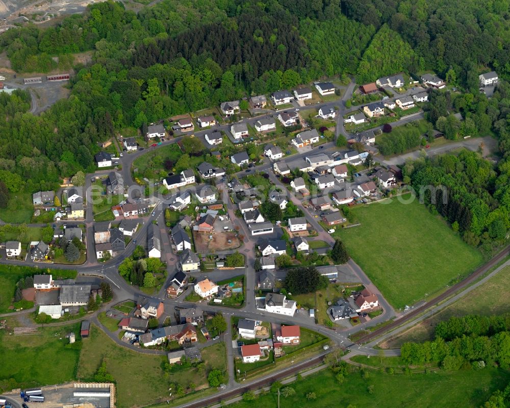 Enspel from the bird's eye view: View of Enspel in the state of Rhineland-Palatinate. The borough and municipiality Enspel is located in the county district of Westerwaldkreis and surrounded by fields, meadows and forest. It is characterised by its location on a slope of the Stoeffel mountain, a basalt mountain