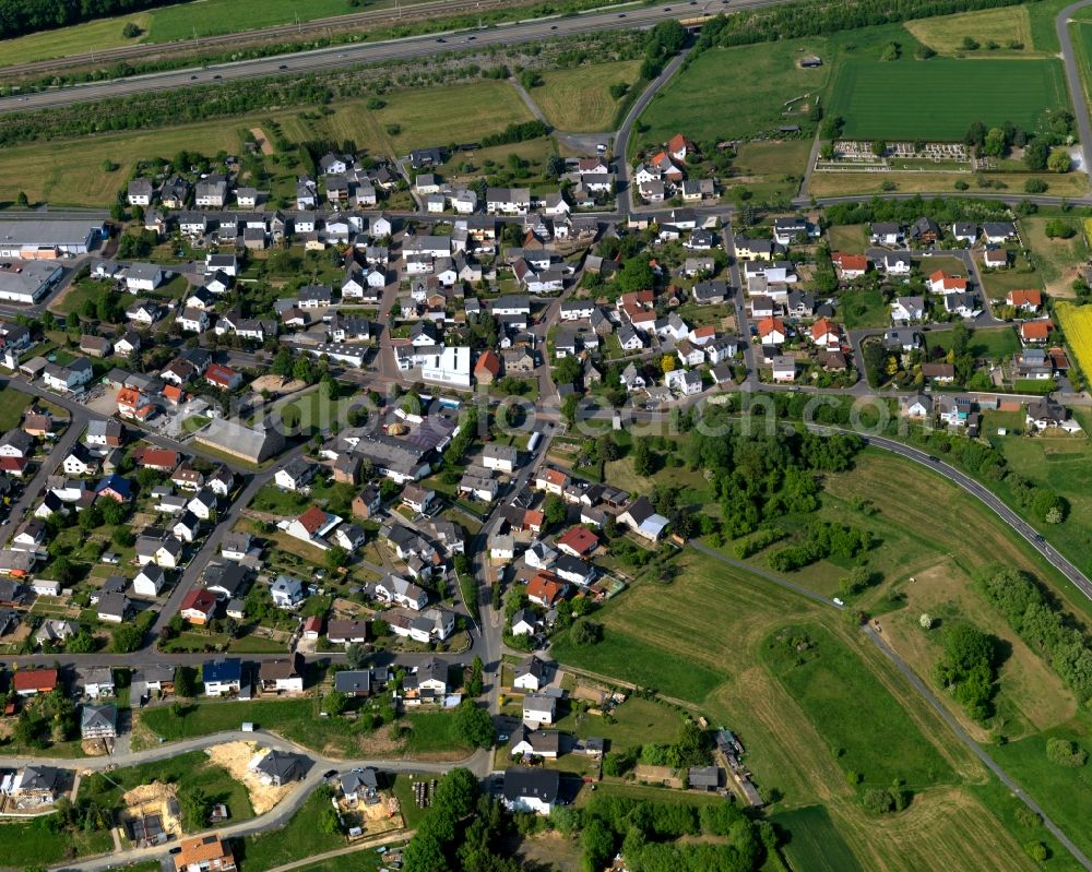 Görgeshausen from the bird's eye view: View of Goergeshausen in the state of Rhineland-Palatinate. The borough and municipiality is located in the county district of Westerwaldkreis in the low mountain range of Westerwald in the South of the federal motorway A3. Goergeshausen is surrounded by agricultural land, forest and meadows