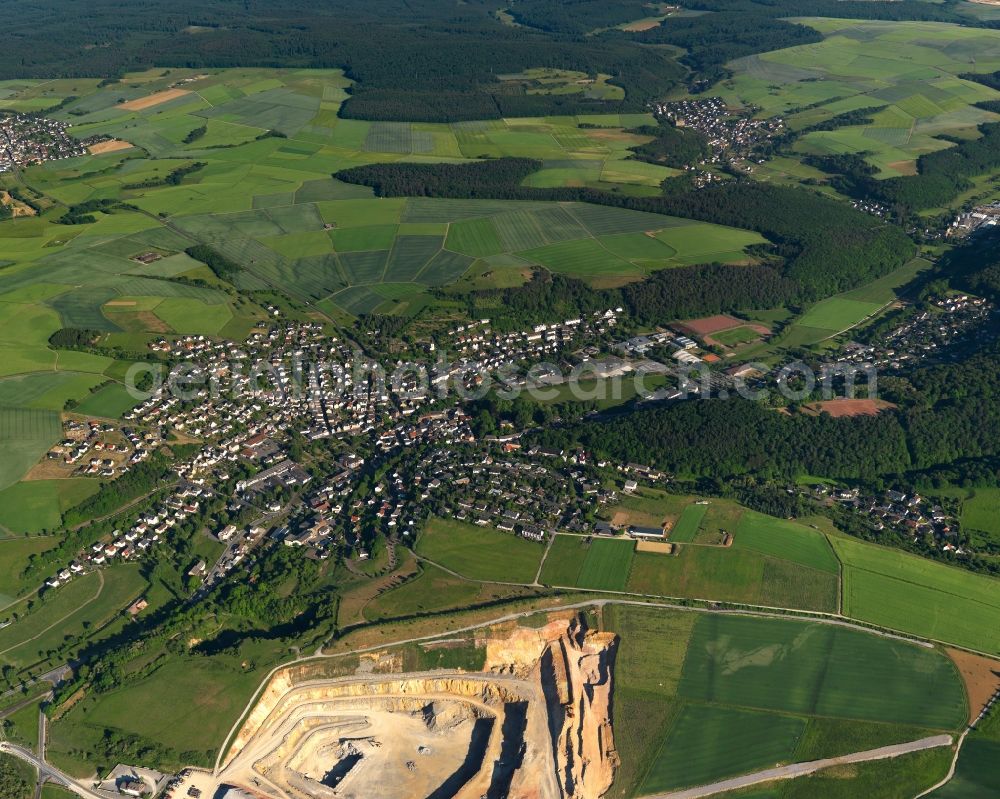 Aerial photograph Hahnstätten - View of the borough of Hahnstaetten in the state of Rhineland-Palatinate. The borough and municipiality is located in the county district of Rhine-Lahn. The agricultural village consists of residential buildings and areas, is an official tourist resort and is surrounded by meadows and fields. A chalk-pit and limestone quarry is located in the North of the borough