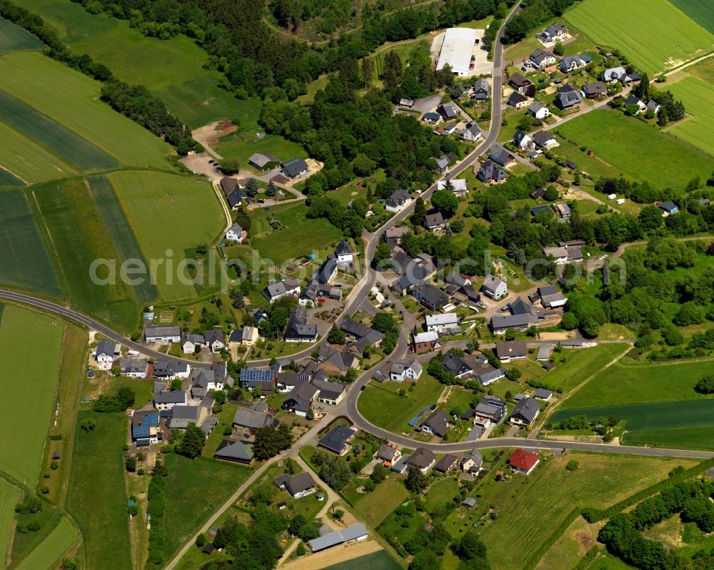 Aerial image Hausbay - View of the borough of Hausbay in the state of Rhineland-Palatinate. The borough and municipiality is located in the county district of Rhine-Hunsrueck, in the Hunsrueck region. The village consists of residential areas and is surrounded by fields and meadows. It is the site of origin of the Baybach creek