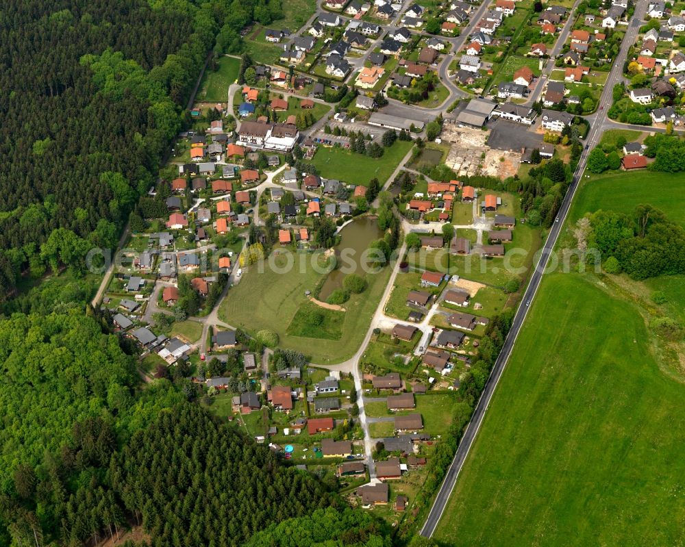 Aerial image Helferskirchen - View of the borough of Helferskirchen in the state of Rhineland-Palatinate. The borough and municipiality is located in the county district of Westerwaldkreis. The official tourist resort consists of residential areas and is surrounded by forest and meadows