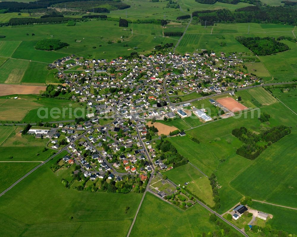 Hellenhahn-Schellenberg from the bird's eye view: View of the borough of Hellenhahn-Schellenberg in the state of Rhineland-Palatinate. The borough is located in the county district and region of Westerwald. The residential village is surrounded by fields and meadows. It sits right on federal highway B255