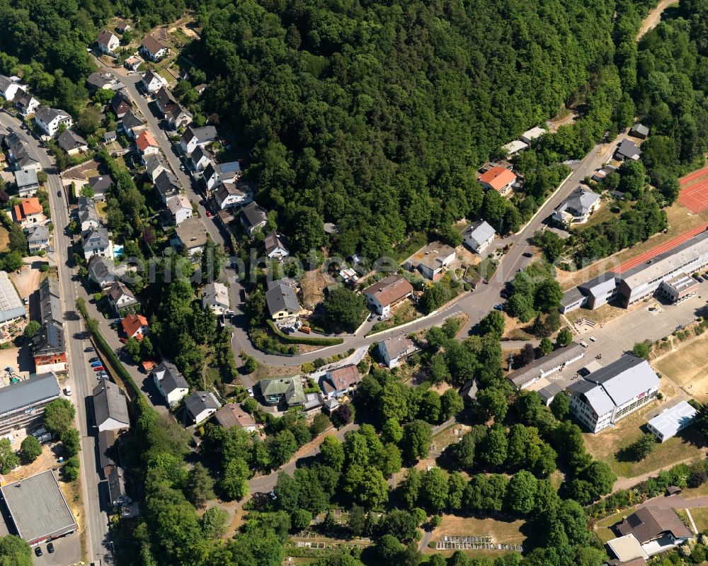 Herrstein from above - View of Herrstein in the state of Rhineland-Palatinate. The borough and municipiality is an official spa resort and located in the county district of Birkenfeld, in the Hunsrueck region at Idar Forest. It is surrounded by agricultural land, meadows and forest and located on Fischbach creek. It is known for the historic town centre and castle Herrstein