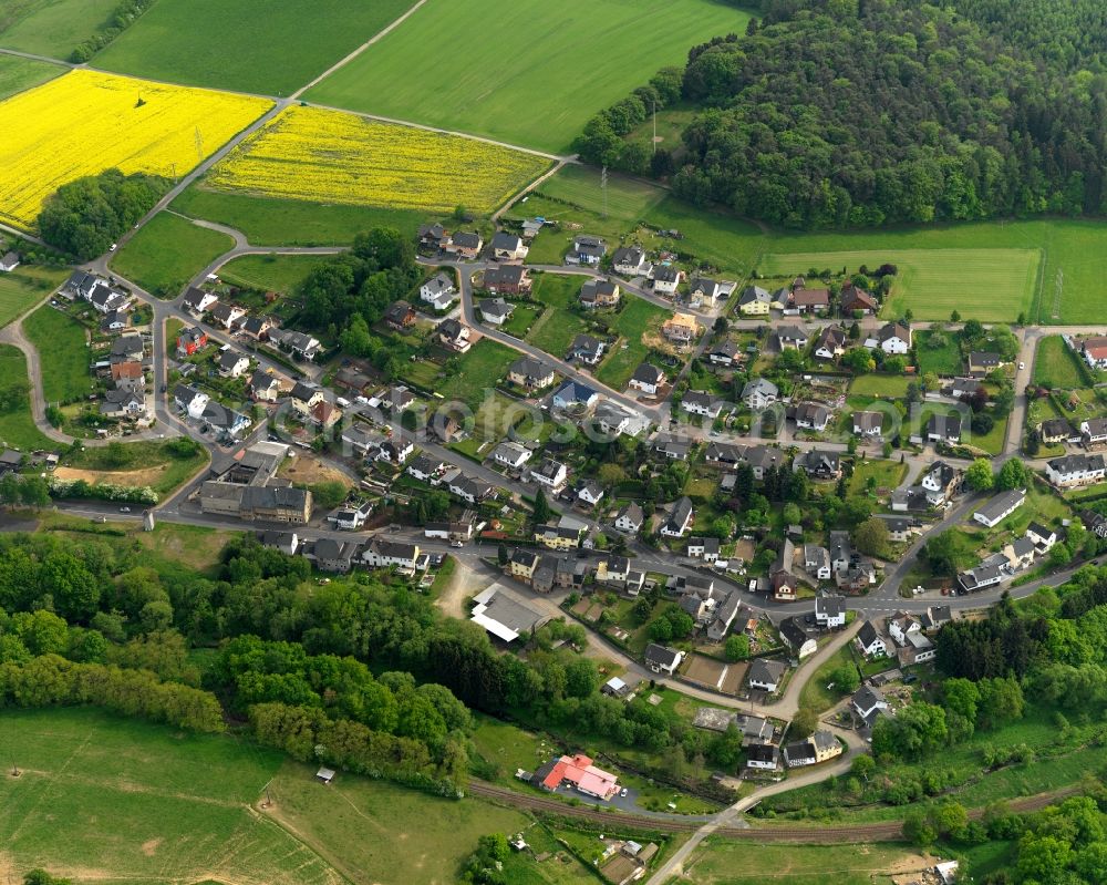 Hundsdorf from above - View of Hundsdorf in the state of Rhineland-Palatinate. The borough and municipiality is located in the county district of Westerwaldkreis in the low mountain range of Westerwald - the so called Kannenbaeckerland. Hundsdorf is surrounded by agricultural land, hills, canola fields and meadows