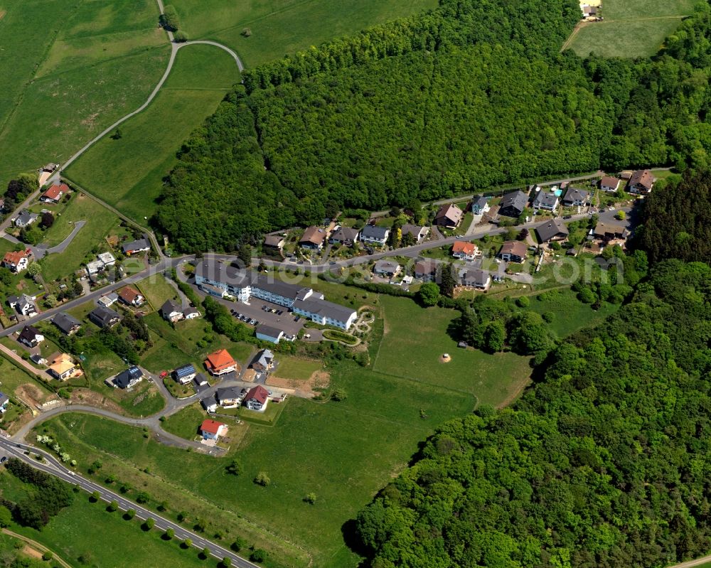 Aerial image Irmtraut - View of the borough of Irmtraut in the state of Rhineland-Palatinate. The borough is located in the county district and region of Westerwald. The residential village is surrounded by fields and meadows, consits of single family houses and is located on a forest on federal highway B 54