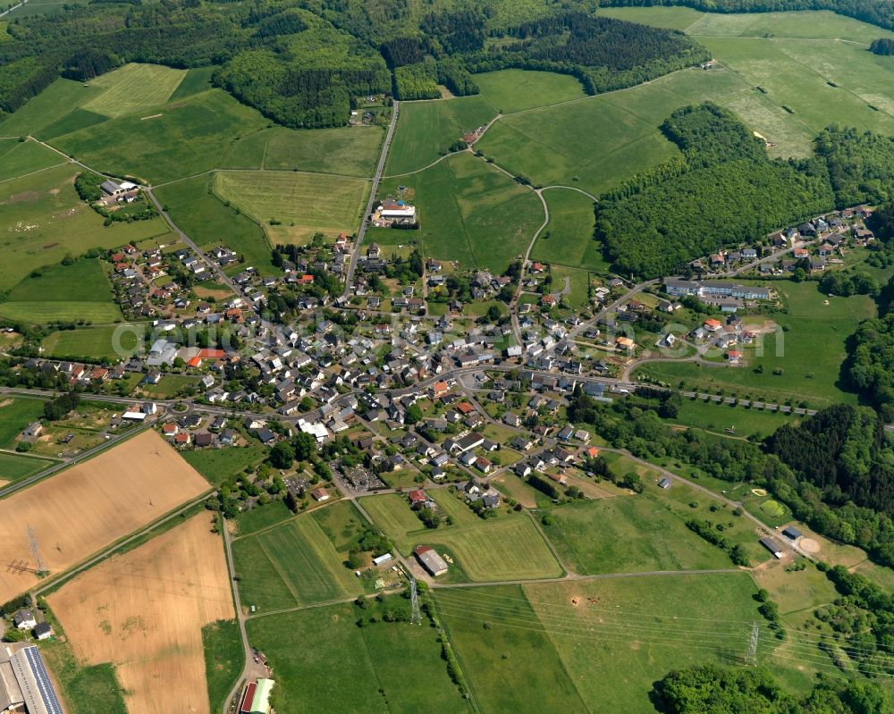 Aerial photograph Irmtraut - View of the borough of Irmtraut in the state of Rhineland-Palatinate. The borough is located in the county district and region of Westerwald. The residential village is surrounded by fields and meadows, consits of single family houses and is located on a forest on federal highway B 54