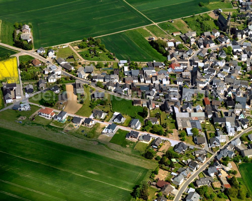 Kehrig from above - View of Kehrig in the state of Rhineland-Palatinate. The borough and municipiality is located in the county district of Mayen-Koblenz and surrounded by rapeseed fields and meadows. It mainly consists of residential areas. Kehrig is located in the Eifel region and includes several hamlets apart from the central village