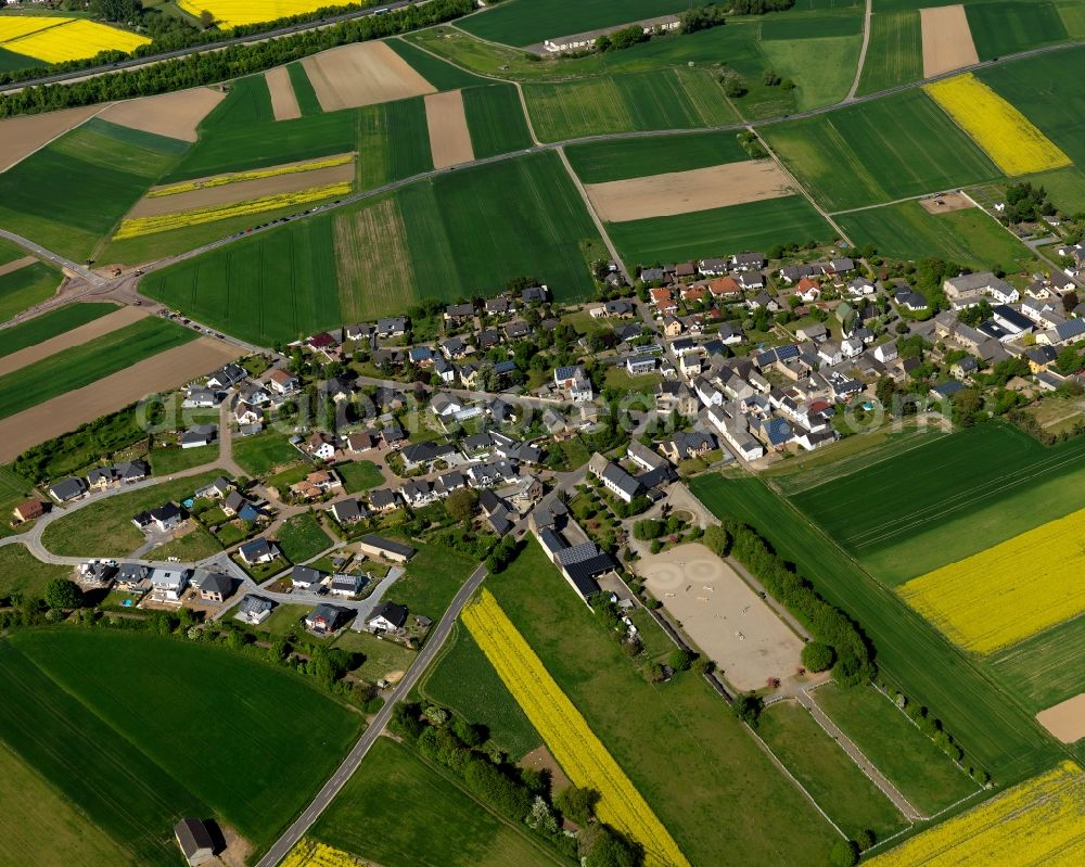 Aerial photograph Kerben - View of Kerben in the state of Rhineland-Palatinate. The agricultural borough and municipiality is located in the county district of Mayen-Koblenz, in the Niedermaifelder Senke region and the South of the federal motorway A48, and is surrounded by meadows and rapeseed fields