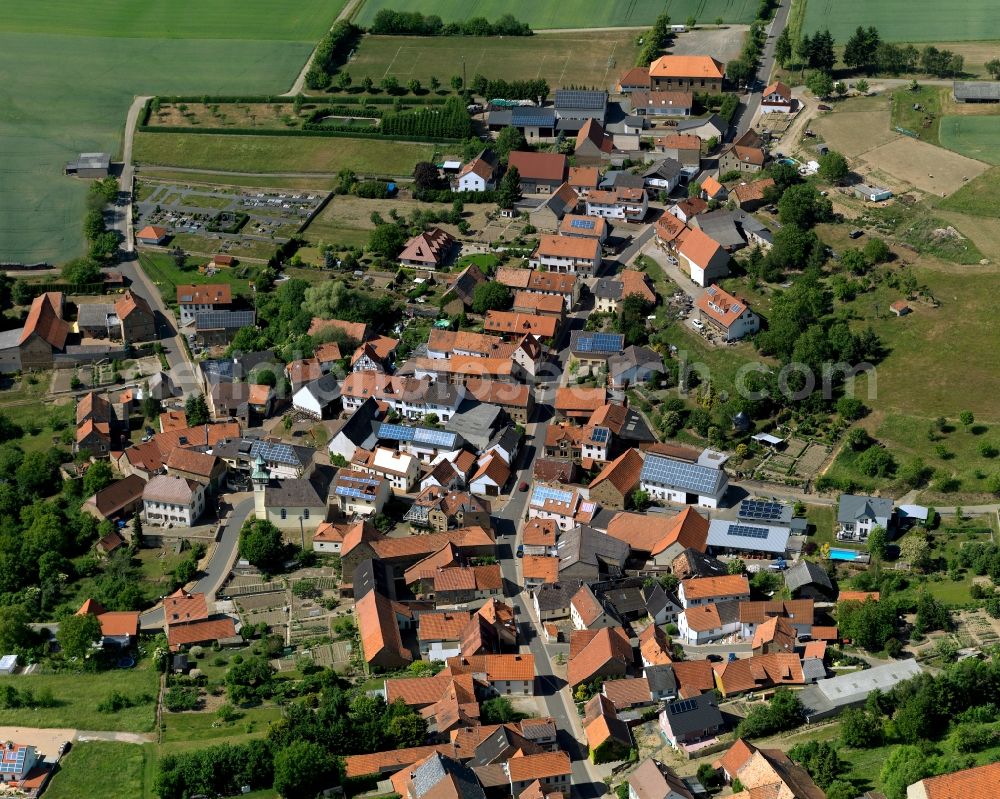 Lettweiler from the bird's eye view: View of the borough and municipiality of Lettweiler in the state of Rhineland-Palatinate. The agricultural borough is located in the county district of Bad Kreuznach. Surrounded by fields, hills and forest, the village is located in the mountain range of Northern Palatinate. Lettweiler is widely known as a wine-growing town and is part of the wine-growing region of Nahe