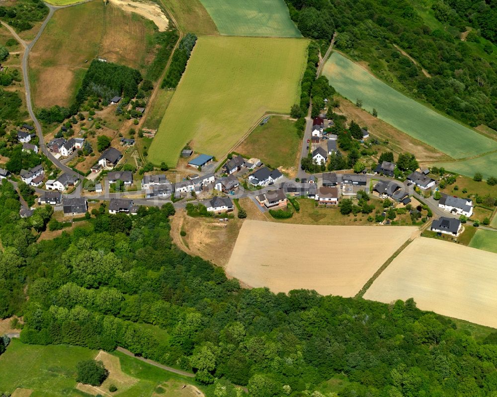 Müllenbach from the bird's eye view: View of Muellenbach in the state of Rhineland-Palatinate. The borough and municipiality is located in the county district of Cochem-Zell in the Eifel region. It is surrounded by agricultural land, meadows and forest