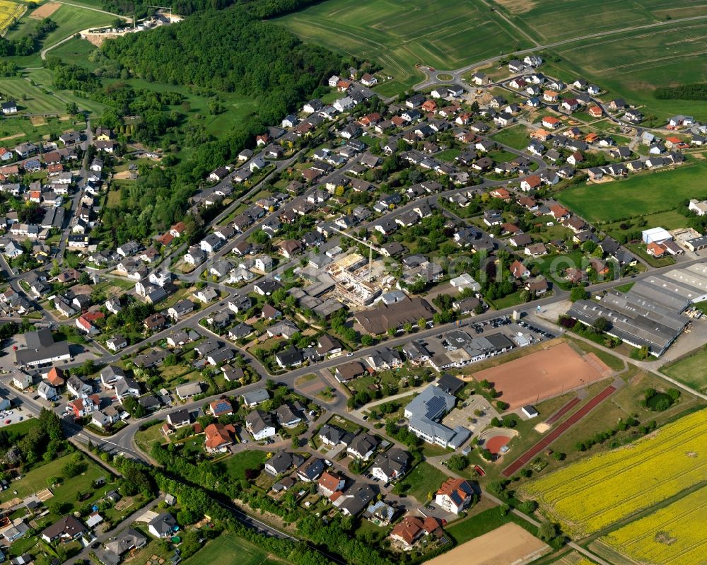 Aerial photograph Nentershausen - View of Nentershausen in the state of Rhineland-Palatinate. The borough and municipiality is located in the county district of Westerwaldkreis in the South of the low mountain range of Westerwald. Nentershausen is surrounded by agricultural land, forest and meadows. It includes two hamlets. Sports facilities including a football pitch are located in the South of the centre of the village