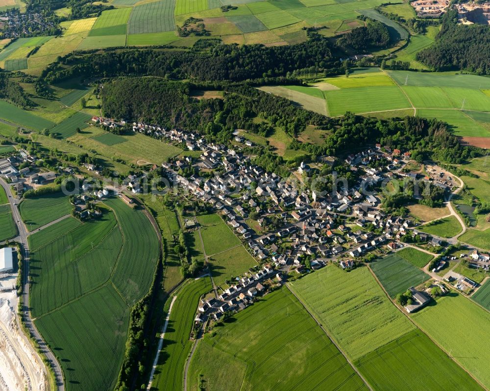 Oberneisen from above - View of the borough of Oberneisen in the state of Rhineland-Palatinate. The borough and municipiality is located in the county district of Rhine-Lahn. The agricultural village consists of residential buildings and areas and is surrounded by meadows and fields