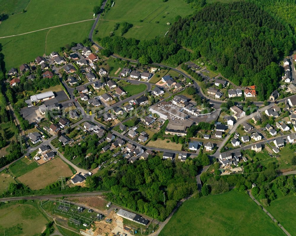 Ruppach-Goldhausen from the bird's eye view: View of Ruppach-Goldhausen in the state of Rhineland-Palatinate. The borough and municipiality is located in the county district of Westerwaldkreis in the low mountain range of Westerwald in the North of the federal motorway A3. Ruppach-Goldhausen is surrounded by agricultural land, forest and meadows and located on the foot of Rupberg mountain and Ahrbach creek
