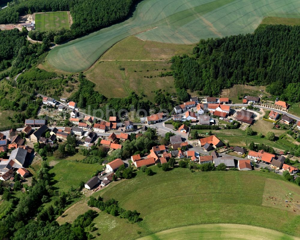 Aerial photograph Schmittweiler - View of the borough and municipiality of Schmittweiler in the state of Rhineland-Palatinate. The agricultural borough is located in the county district of Bad Kreuznach. Surrounded by fields, hills and forest, the village is located in the mountain range of Northern Palatinate - in the valley of the Eschelbach creek