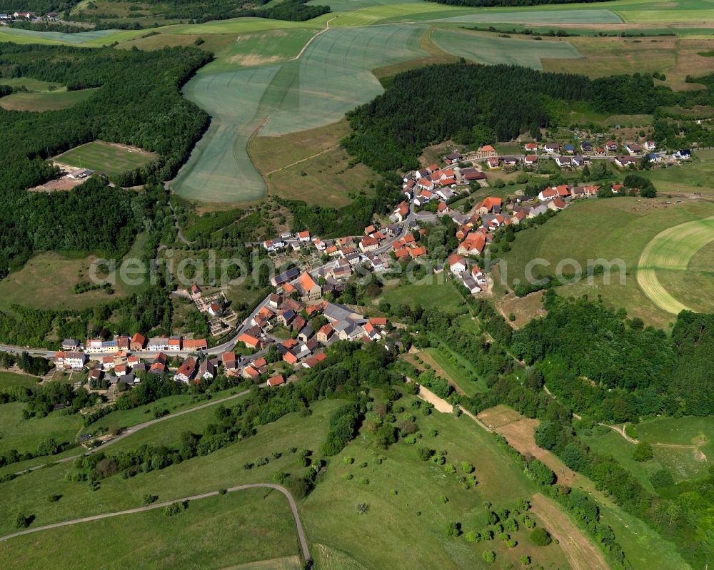 Schmittweiler from above - View of the borough and municipiality of Schmittweiler in the state of Rhineland-Palatinate. The agricultural borough is located in the county district of Bad Kreuznach. Surrounded by fields, hills and forest, the village is located in the mountain range of Northern Palatinate - in the valley of the Eschelbach creek