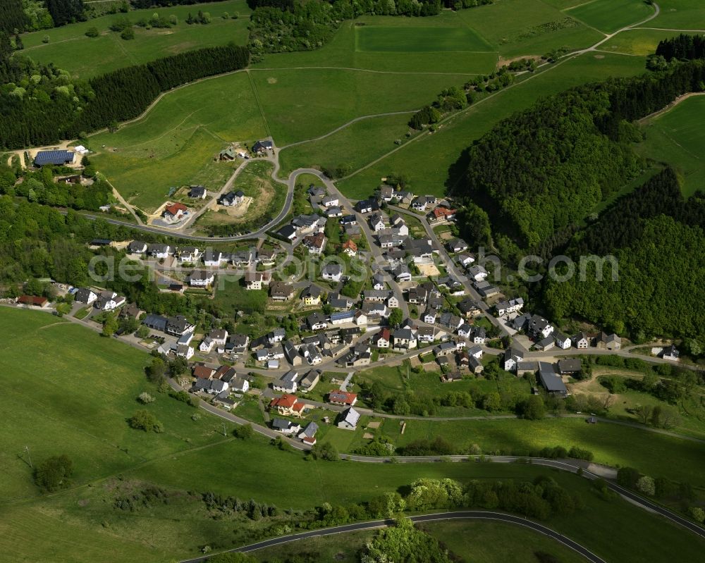 Siebenbach from above - View of the borough of Siebenbach in the state of Rhineland-Palatinate. Siebenbach is located close to the Hohe Acht, the highest mountain range of the Eifel region. View of the centre of the borough with residential areas, agricultural land and farms, surrounded by forest and hills