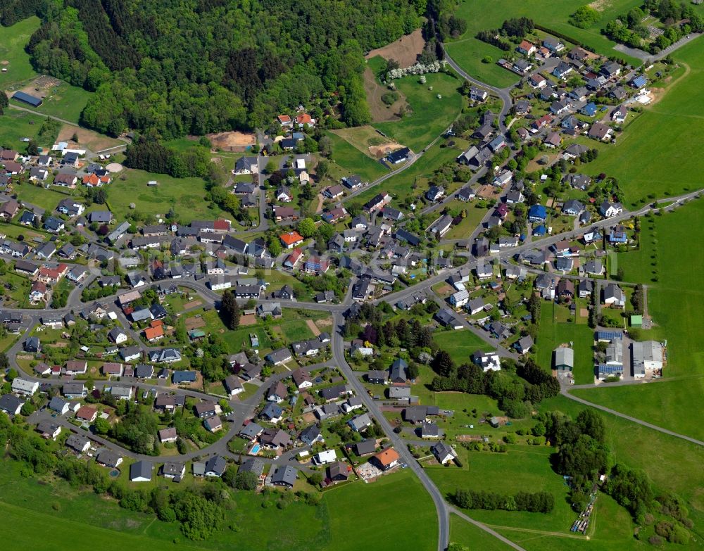 Weitefeld from the bird's eye view: View of Weitefeld in the state of Rhineland-Palatinate. The borough and municipiality Weitefeld is located in the county district of Altenkirchen in the Westerwald forest region and surrounded by fields, meadows and forest. It sits on a hill