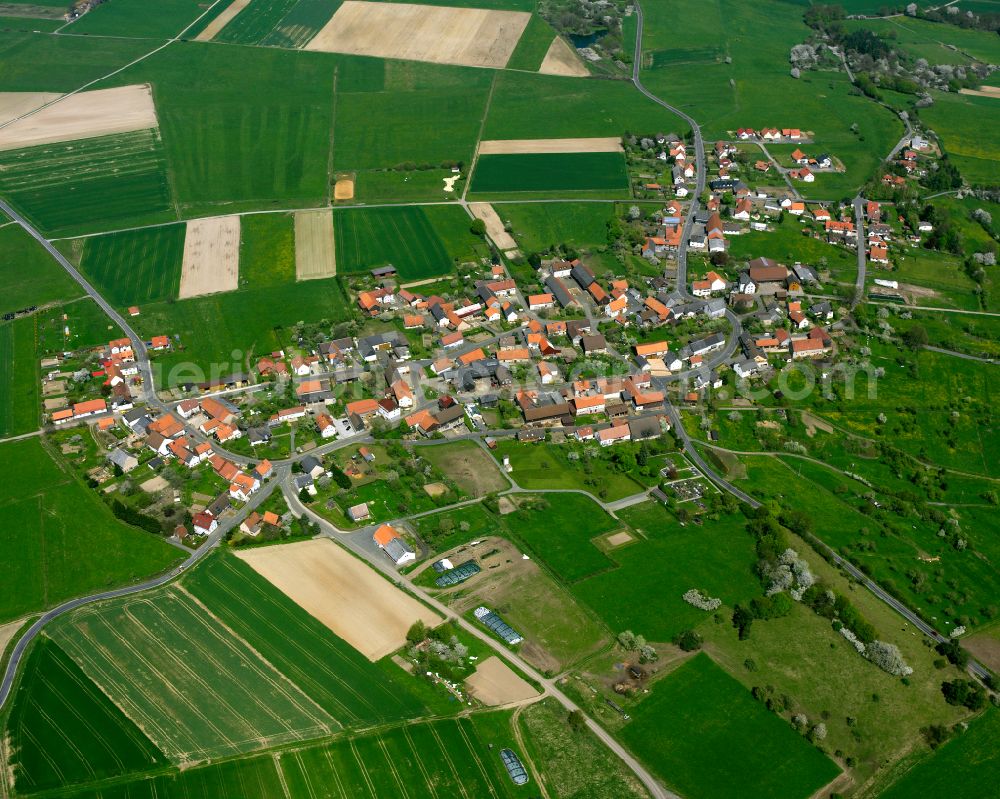 Arnshain from the bird's eye view: Village view on the edge of agricultural fields and land in Arnshain in the state Hesse, Germany