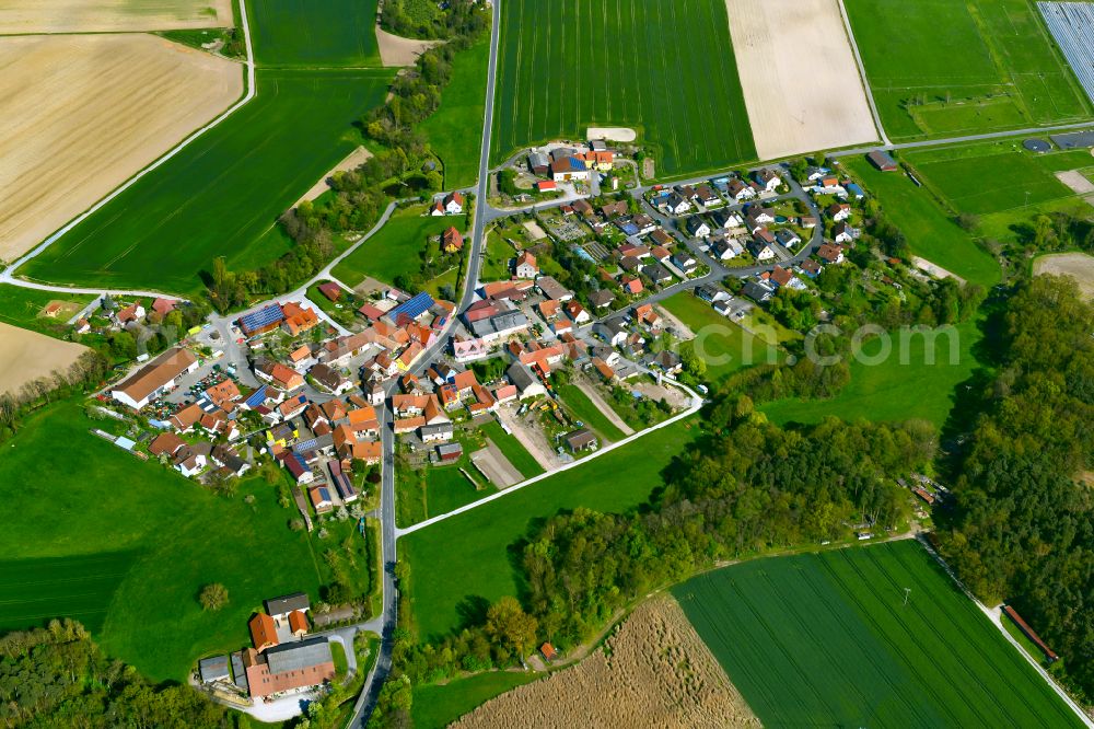 Atzhausen from the bird's eye view: Village view on the edge of agricultural fields and land in Atzhausen in the state Bavaria, Germany