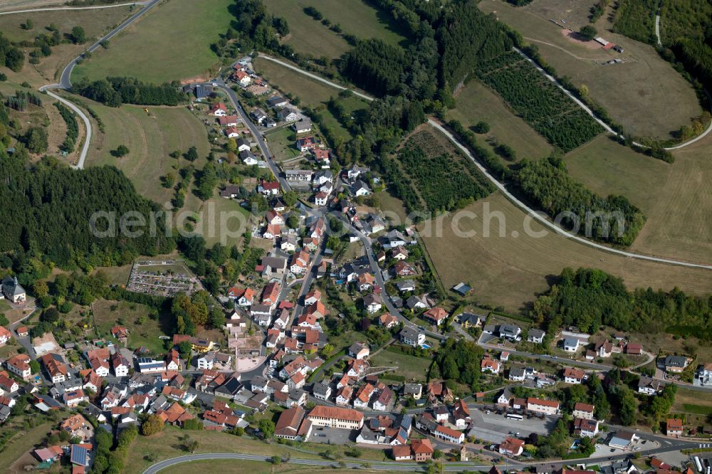 Aura im Sinngrund from the bird's eye view: Village view on the edge of agricultural fields and land in Aura im Sinngrund in the state Bavaria, Germany