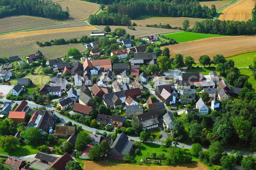 Azendorf from the bird's eye view: Village view on the edge of agricultural fields and land in Azendorf in the state Bavaria, Germany