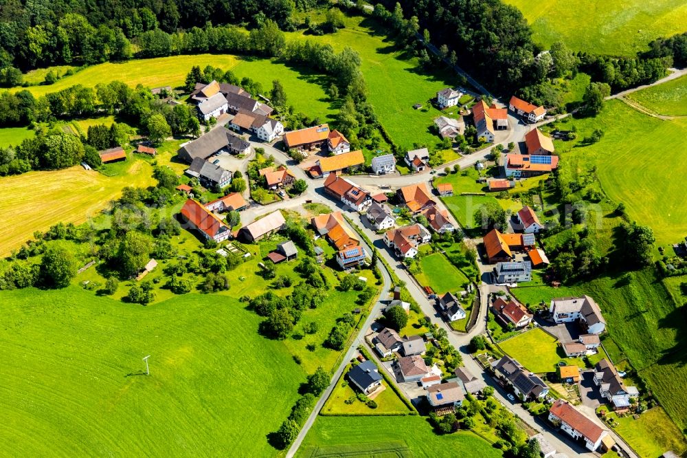 Benkhausen from the bird's eye view: Village view on the edge of agricultural fields and land in Benkhausen in the state Hesse, Germany