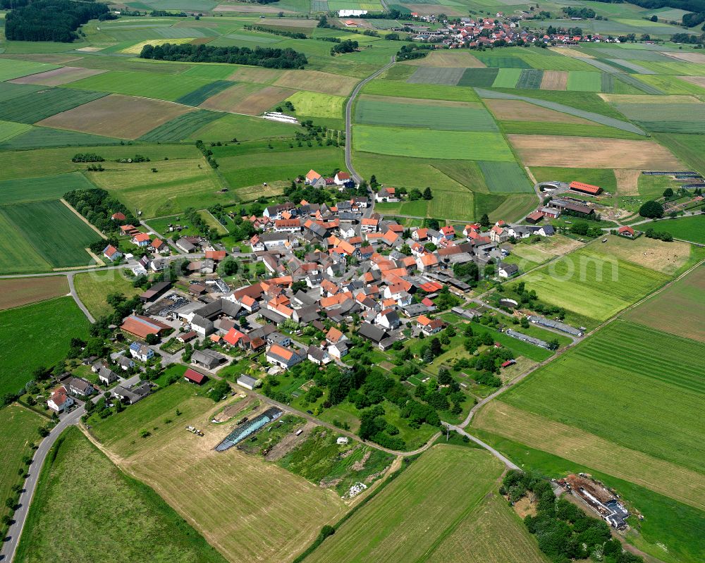 Bleidenrod from the bird's eye view: Village view on the edge of agricultural fields and land in Bleidenrod in the state Hesse, Germany