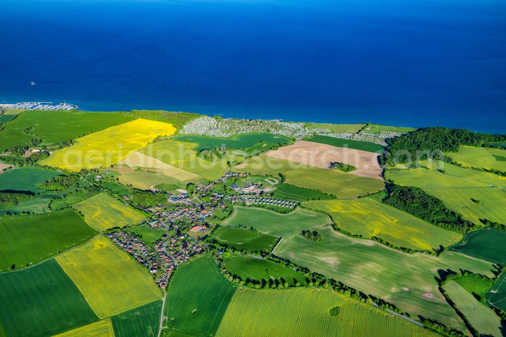 Bliesdorf from the bird's eye view: Village view on the edge of agricultural fields and land in Bliesdorf in the state Schleswig-Holstein, Germany