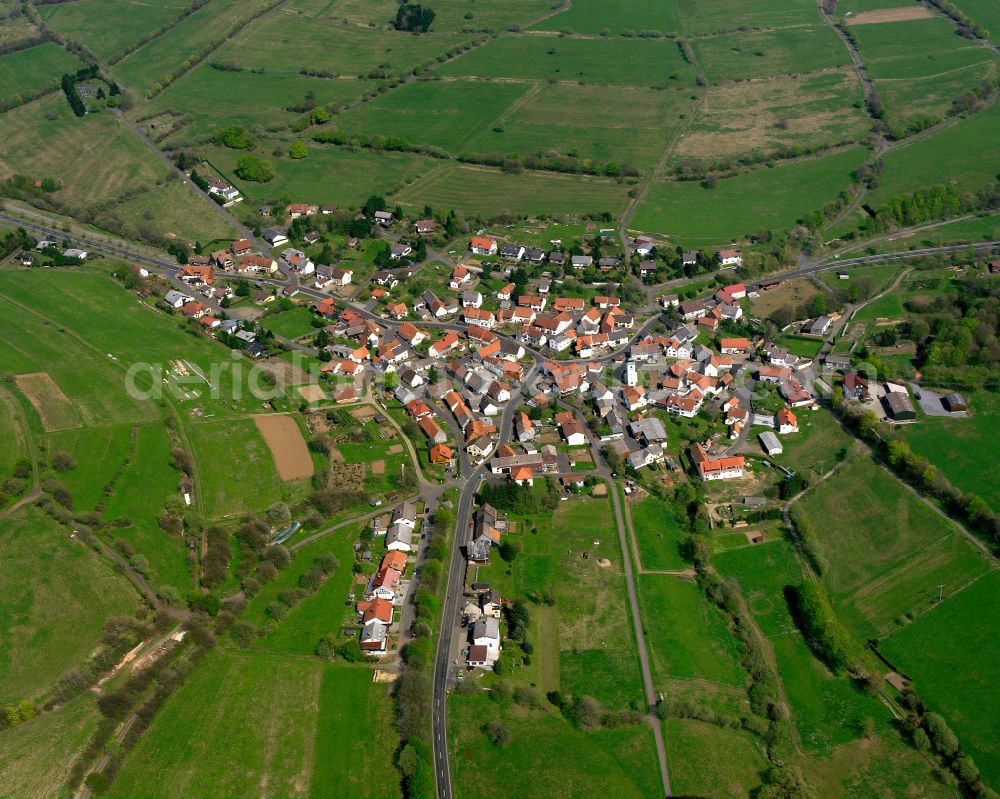 Breungeshain from the bird's eye view: Village view on the edge of agricultural fields and land in Breungeshain in the state Hesse, Germany