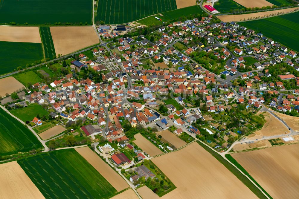 Buchbrunn from above - Village view on the edge of agricultural fields and land in Buchbrunn in the state Bavaria, Germany