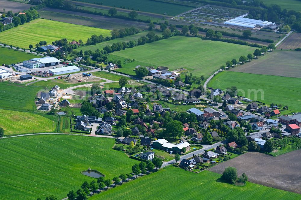 Bullenkuhlen from the bird's eye view: Village view on the edge of agricultural fields and land in Bullenkuhlen in the state Schleswig-Holstein, Germany