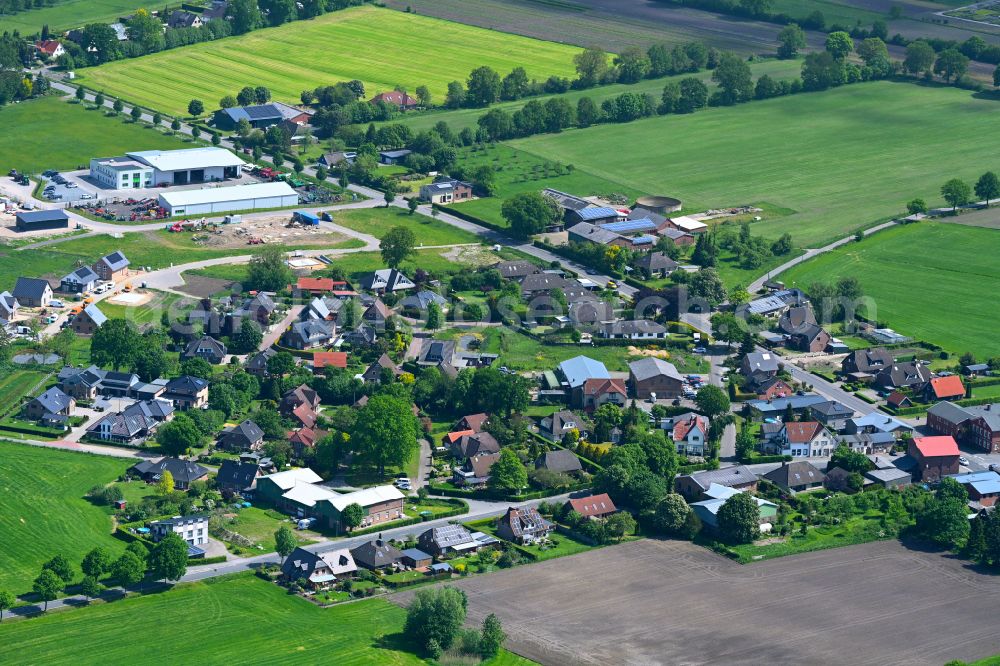 Aerial photograph Bullenkuhlen - Village view on the edge of agricultural fields and land in Bullenkuhlen in the state Schleswig-Holstein, Germany