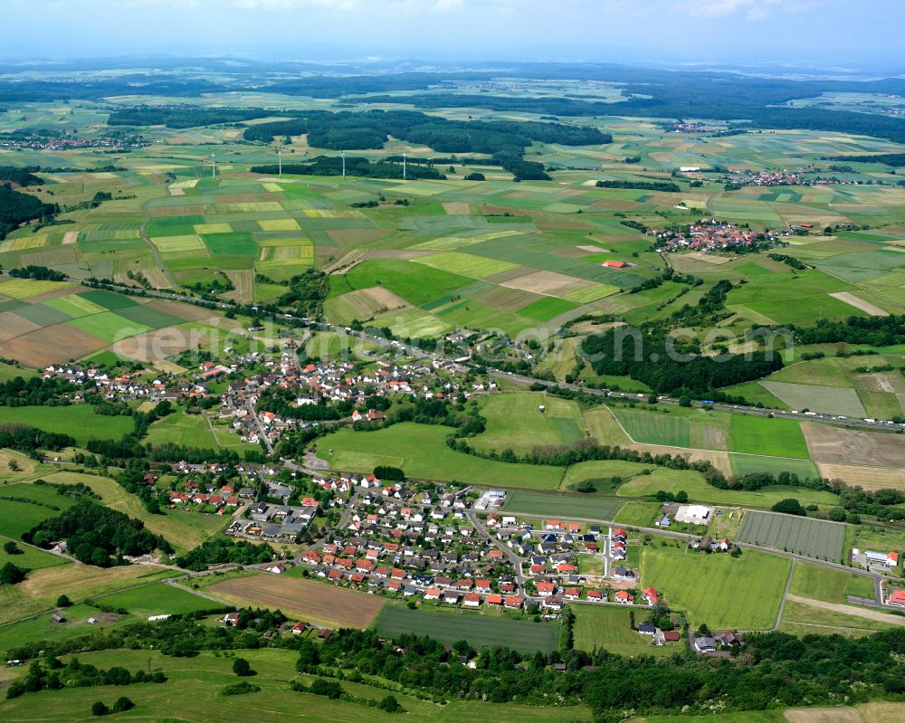 Burg-Gemünden from the bird's eye view: Village view on the edge of agricultural fields and land in Burg-Gemünden in the state Hesse, Germany