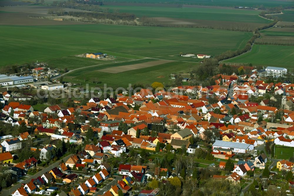 Dachwig from the bird's eye view: Village view on the edge of agricultural fields and land in Dachwig in the state Thuringia, Germany