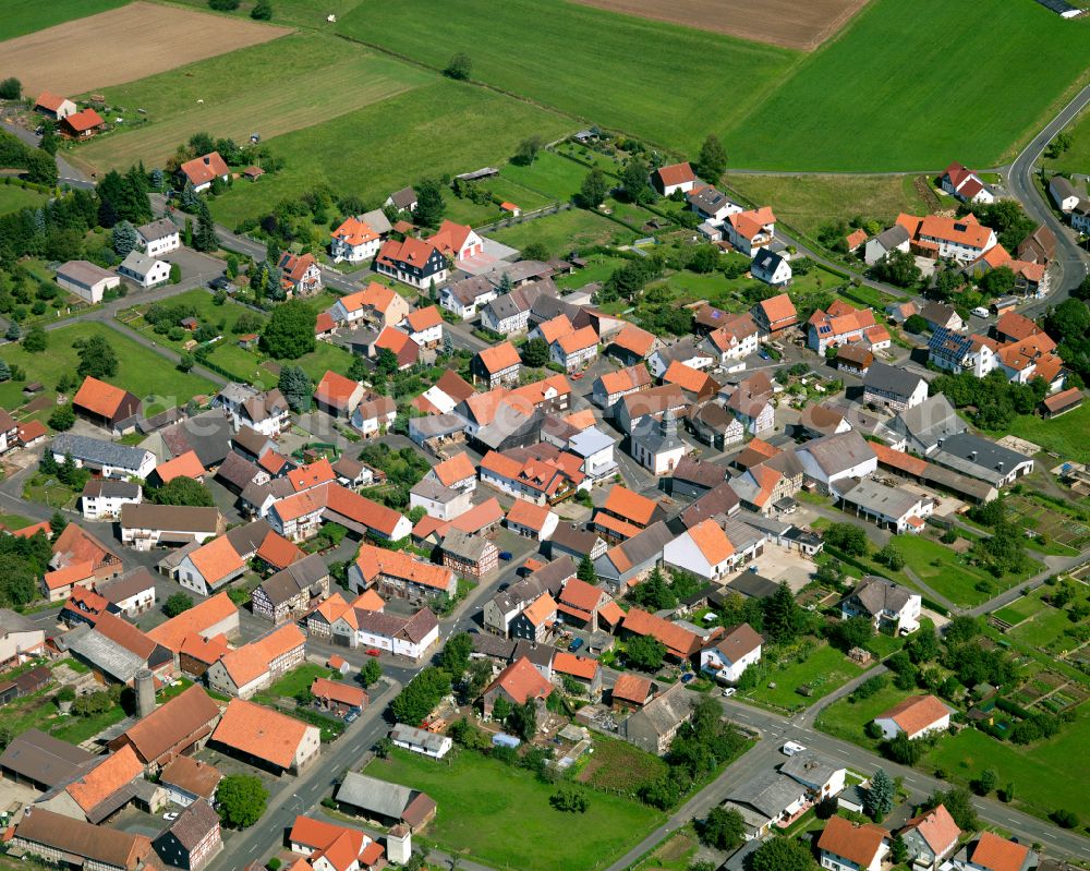 Deckenbach from the bird's eye view: Village view on the edge of agricultural fields and land in Deckenbach in the state Hesse, Germany