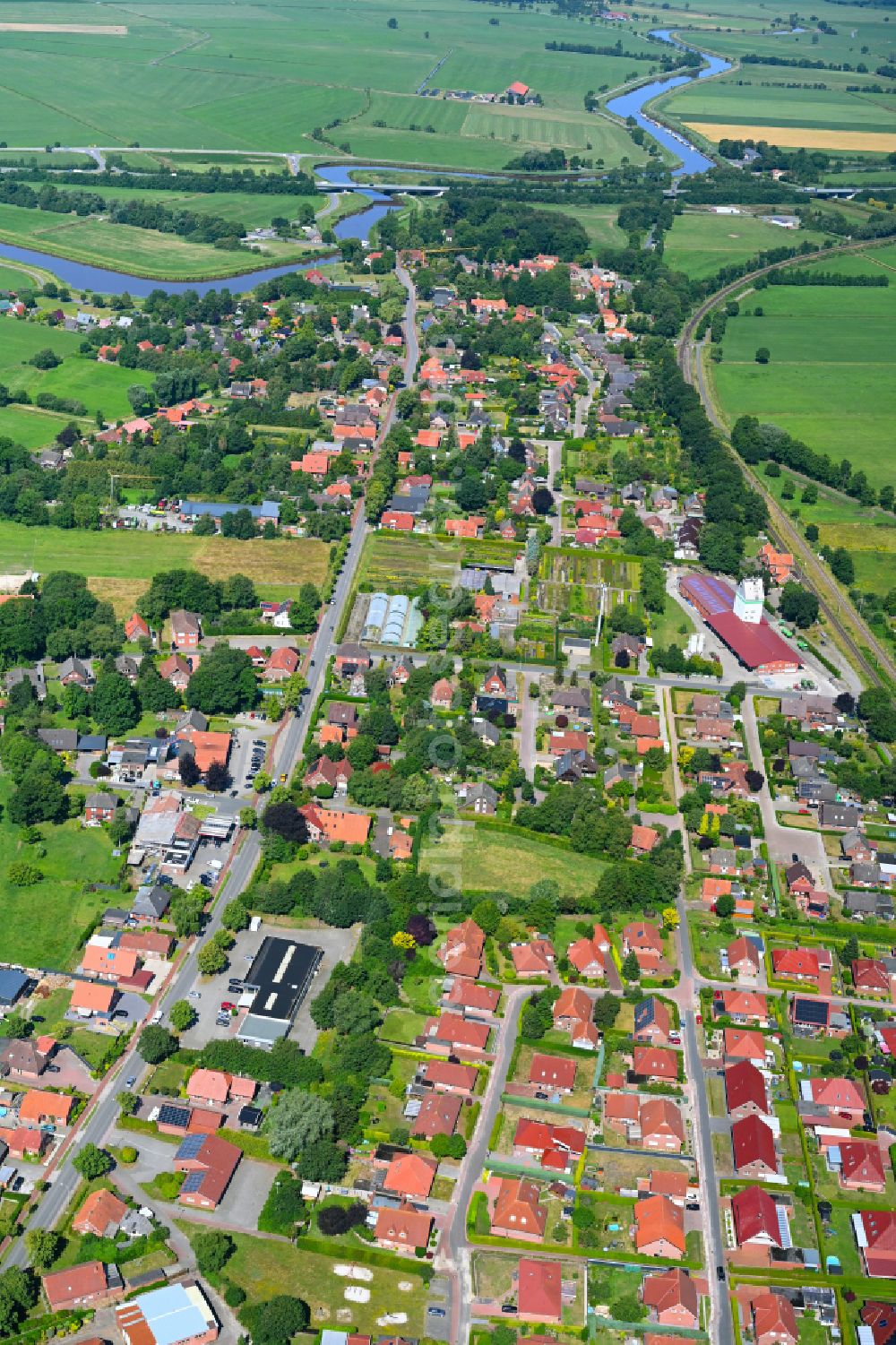 Detern from above - Village view on the edge of agricultural fields and land in Detern in the state Lower Saxony, Germany