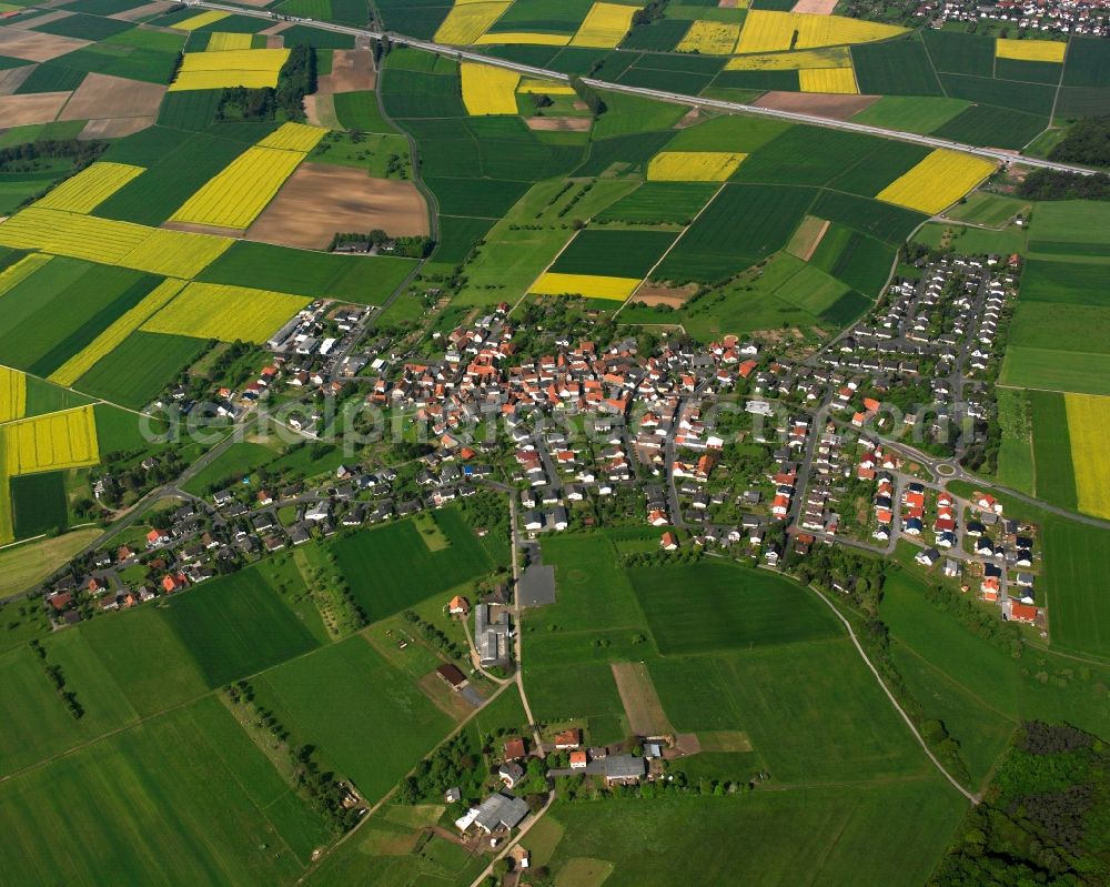 Dorf-Güll from the bird's eye view: Village view on the edge of agricultural fields and land in Dorf-Güll in the state Hesse, Germany