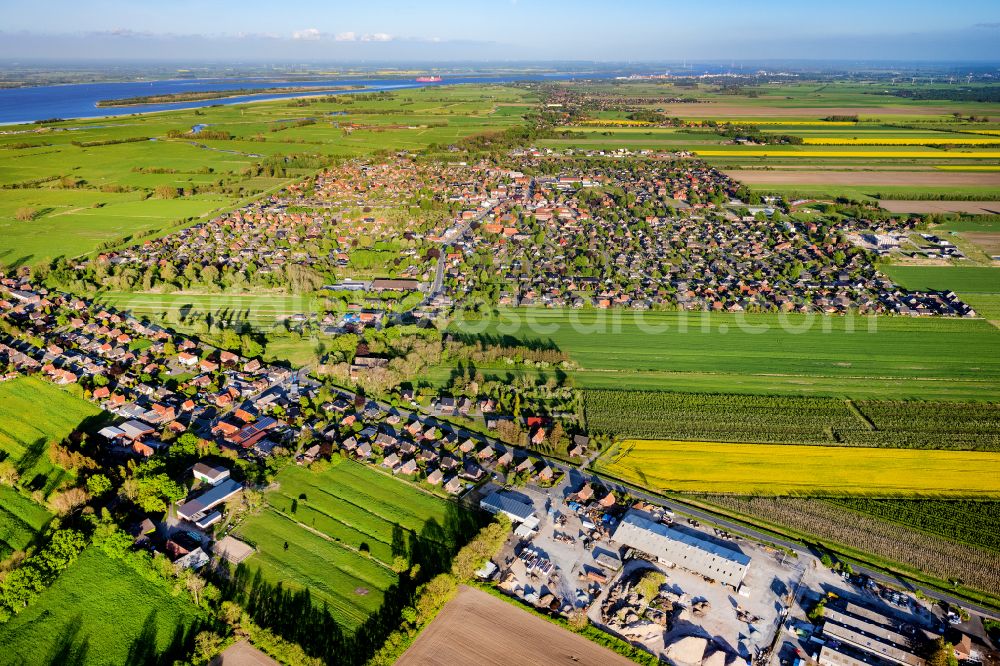 Drochtersen from above - Village view on the edge of agricultural fields and land in Drochtersen in the state Lower Saxony, Germany