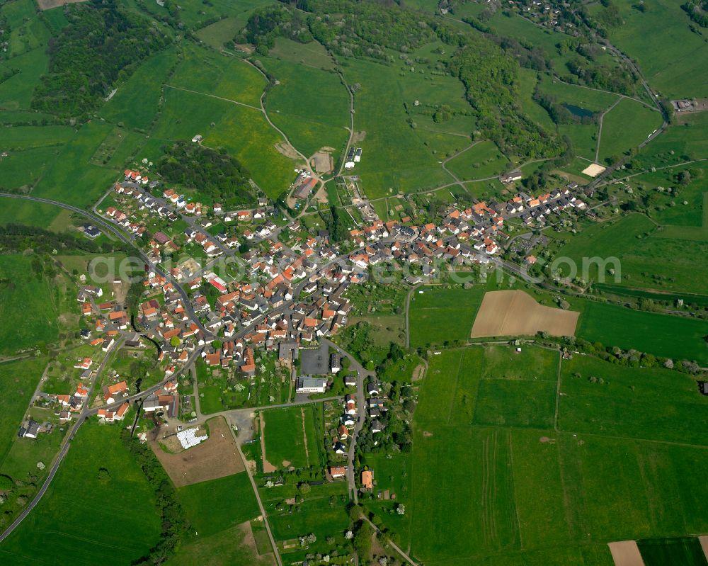 Eichelsachsen from above - Village view on the edge of agricultural fields and land in Eichelsachsen in the state Hesse, Germany