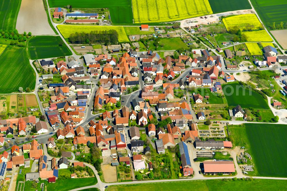 Eichfeld from the bird's eye view: Village view on the edge of agricultural fields and land in Eichfeld in the state Bavaria, Germany