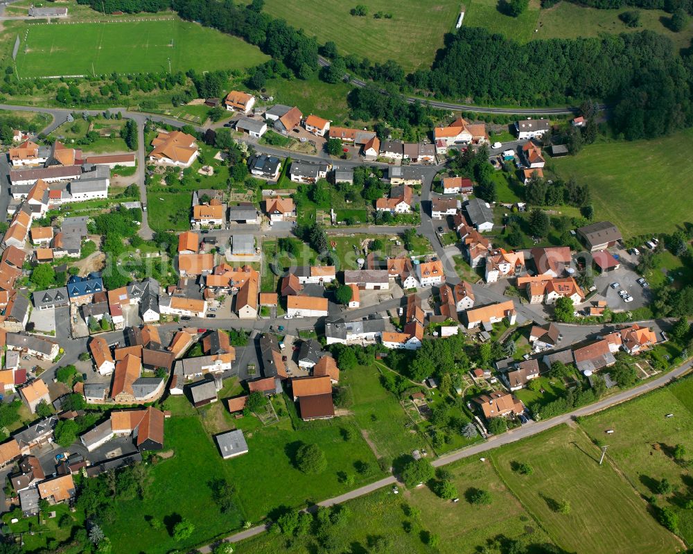 Eschenrod from the bird's eye view: Village view on the edge of agricultural fields and land in Eschenrod in the state Hesse, Germany