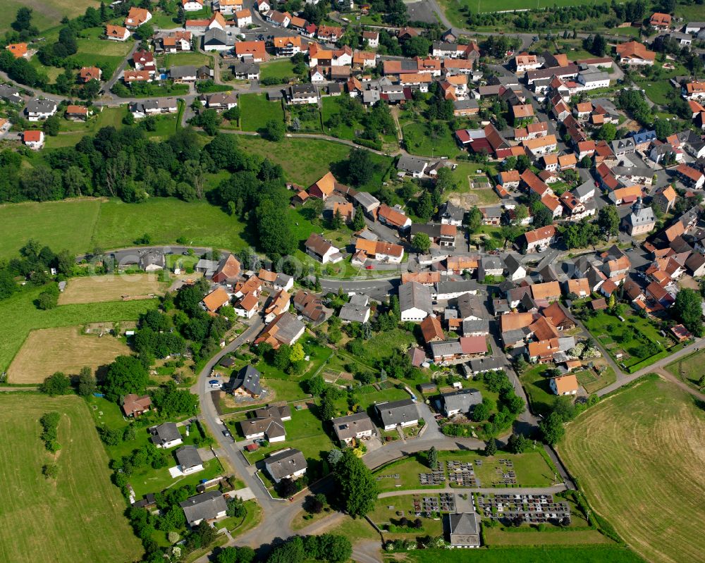 Eschenrod from above - Village view on the edge of agricultural fields and land in Eschenrod in the state Hesse, Germany